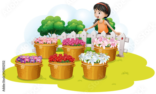 A girl looking at the flowers in the basket