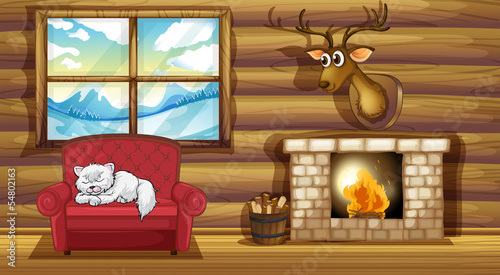 A cat sleeping above the chair near the fireplace