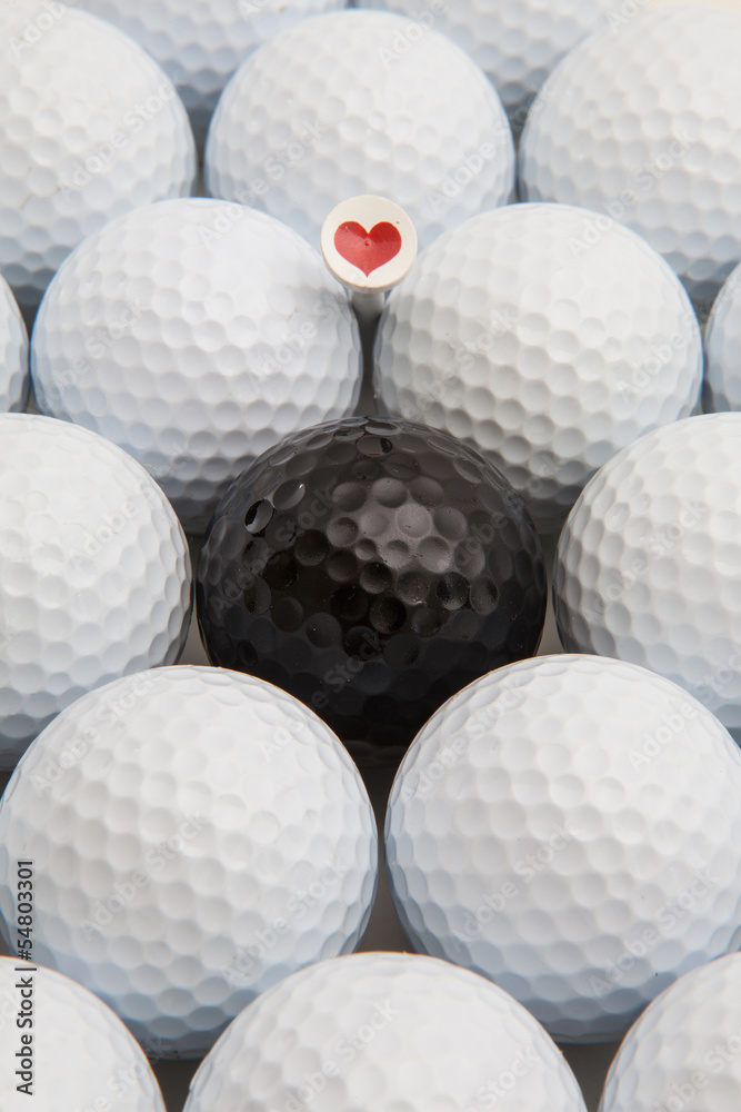 White and black golf balls and wooden tees White and black golf balls and wooden tees