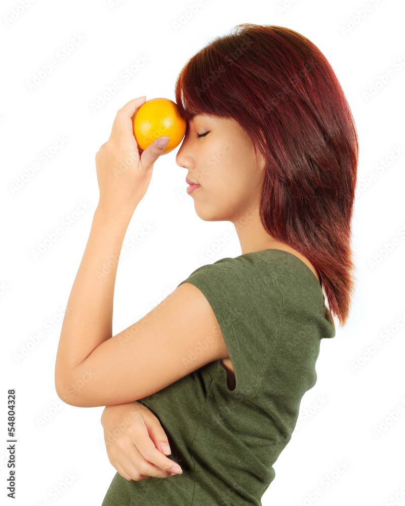 Isolated young asian woman with an orange Isolated young asian woman with an orange