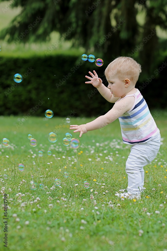 Little cute girl playing with soap bubbles Little cute girl playing with soap bubbles