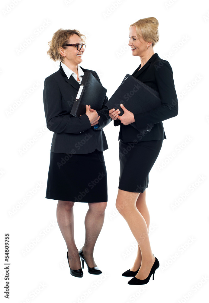 Corporate women interacting with each other Corporate women interacting with each other