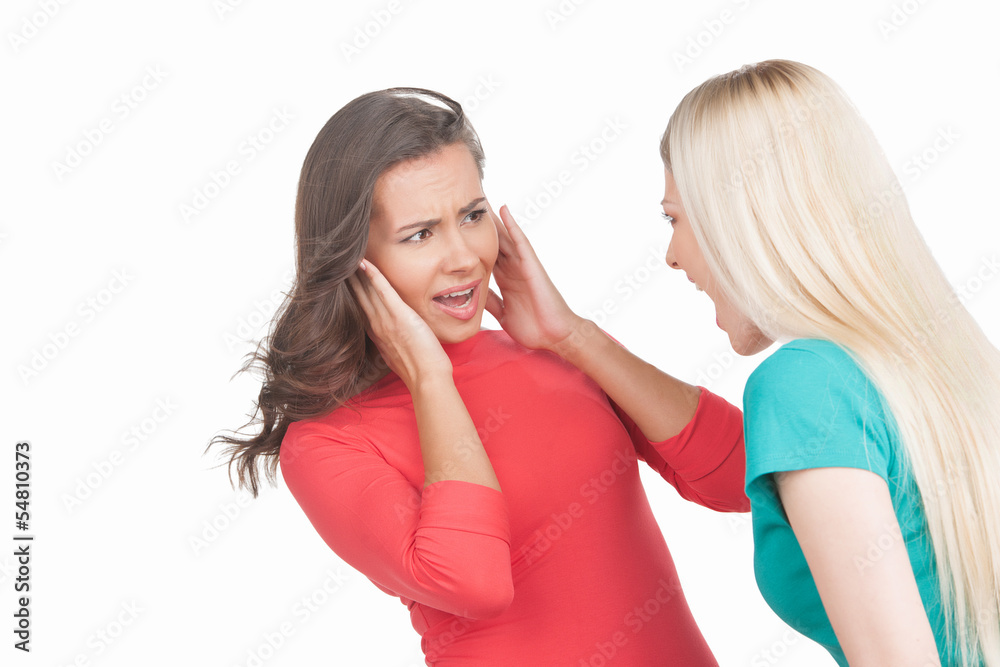 Women shouting. Young blond hair women shouting at the brown hai Women shouting. Young blond hair women shouting at the brown hai