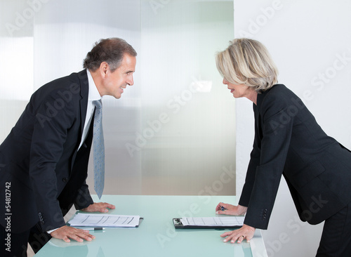 Mature Businessman And Businesswoman Fighting