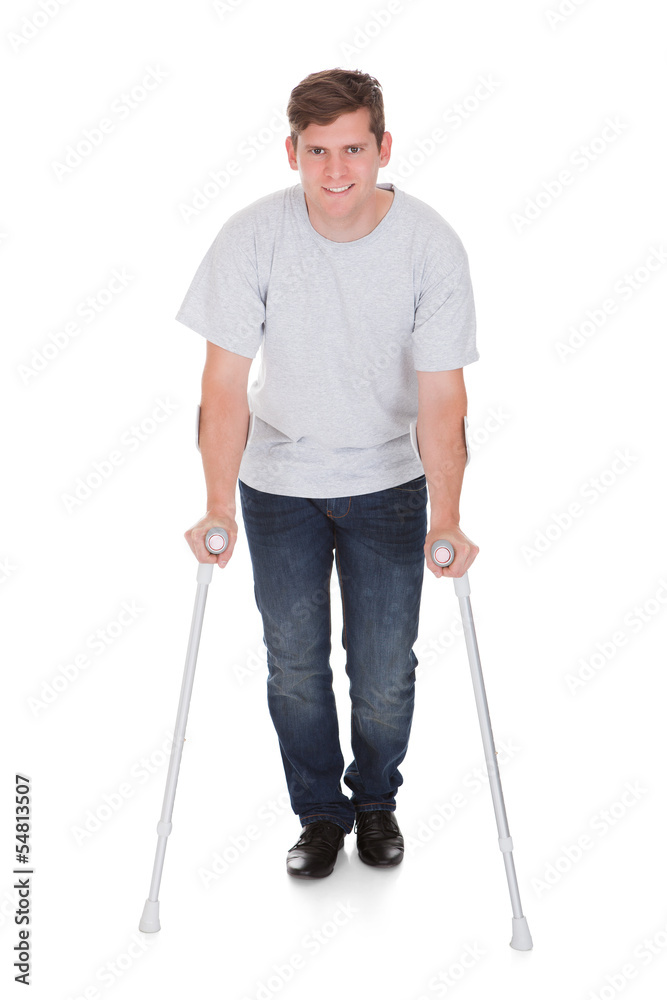 Young Man Walking With Two Crutches