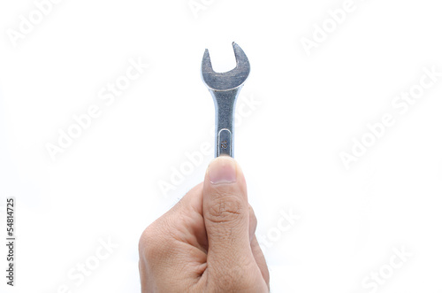 Hand with a new wrench isolated on white