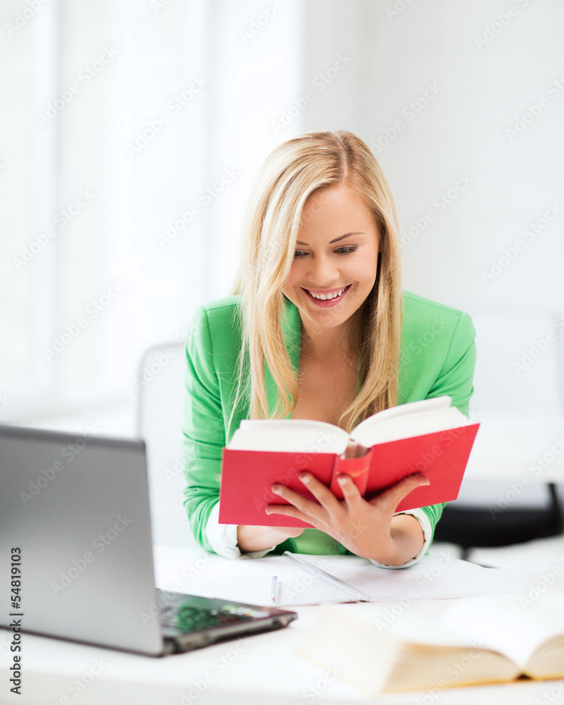 smiling student girl reading book in college smiling student girl reading book in college