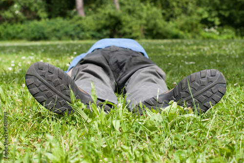 Man resting on meadow in a park