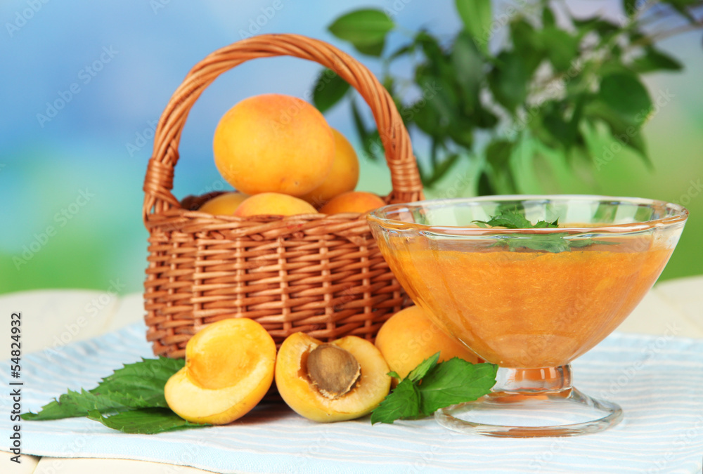 Apricot jam in glass bowl and fresh apricots,