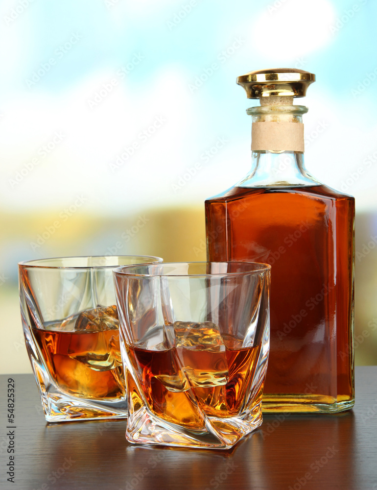 Glass of whiskey with bottle, on dark background Glass of whiskey with bottle, on dark background