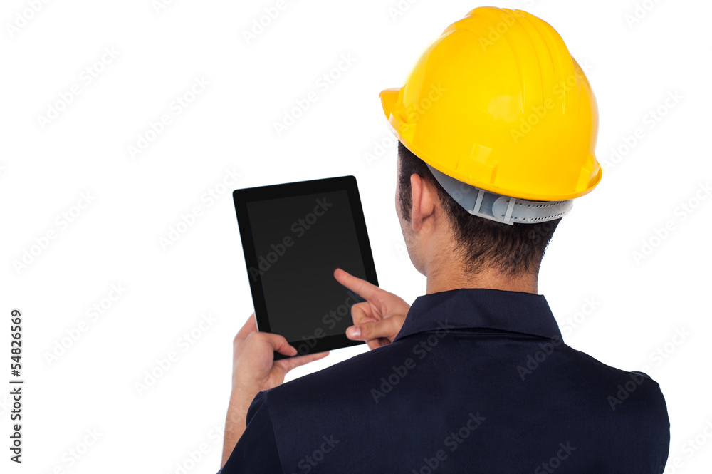 Worker operating tablet device, back pose Worker operating tablet device, back pose