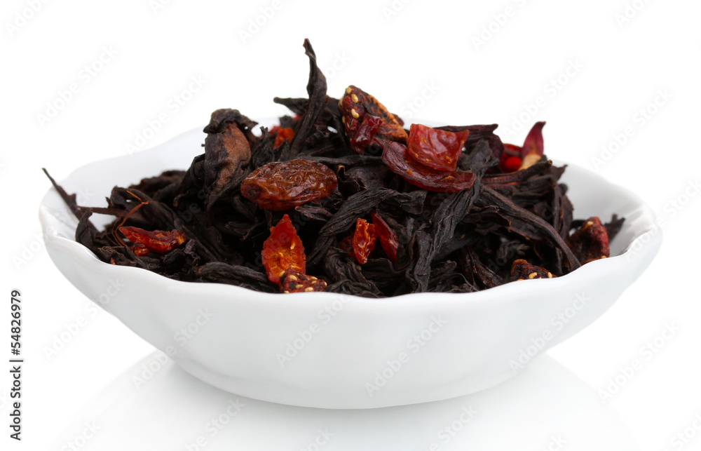 Black dry fruit tea leaves in plate isolated on white Black dry fruit tea leaves in plate isolated on white