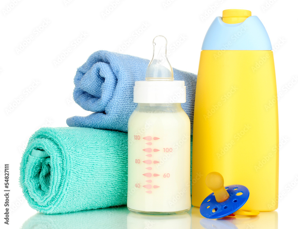 Bottle of milk, pacifier, shampoo and towel isolated on white Bottle of milk, pacifier, shampoo and towel isolated on white