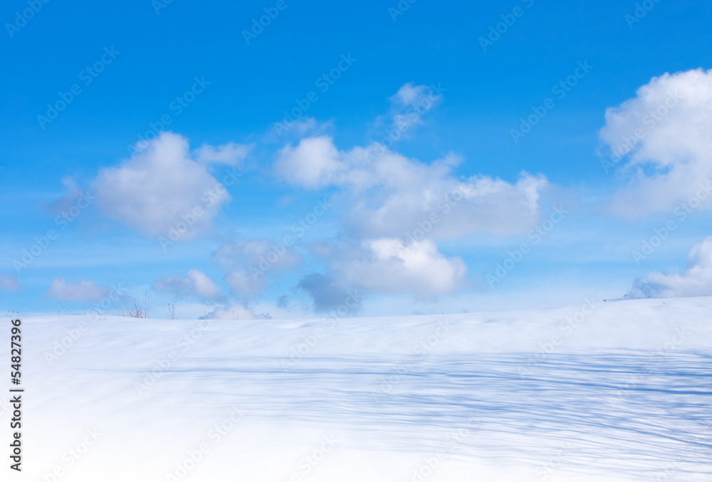 Blue cloudy sky and snow