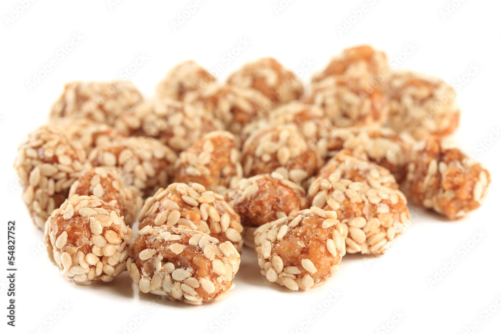 Tasty peanuts with sesame and caramel, isolated on white Tasty peanuts with sesame and caramel, isolated on white