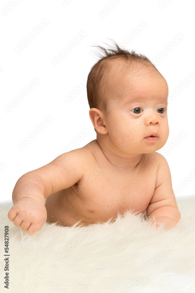 Newborn baby girl lying on her belly on a sheepskin Newborn baby girl lying on her belly on a sheepskin