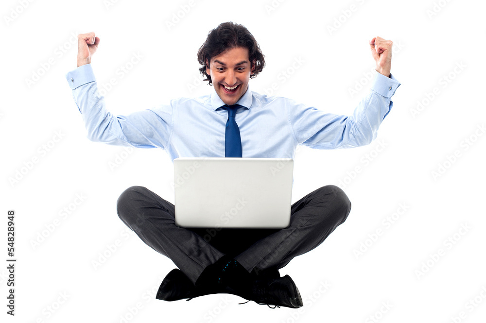 Excited young professional with laptop