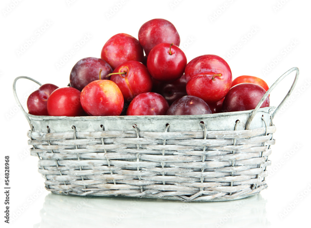 Ripe plums in basket isolated on white Ripe plums in basket isolated on white
