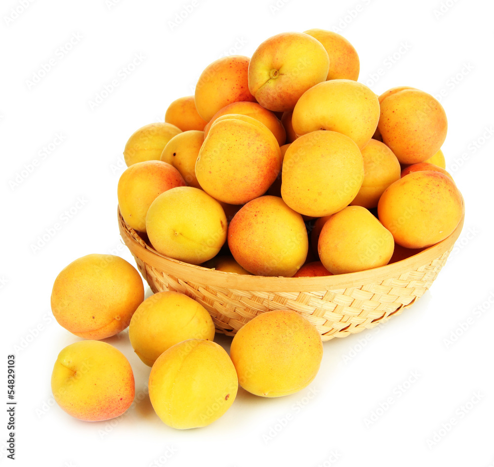 Fresh natural apricot in wicker basket isolated on white Fresh natural apricot in wicker basket isolated on white