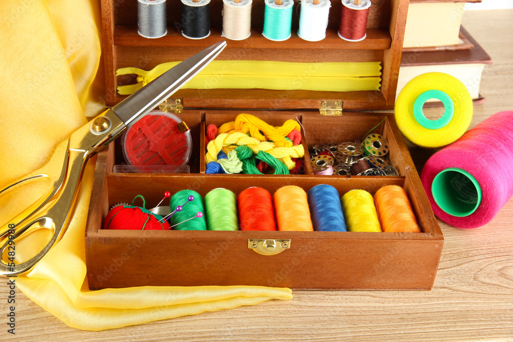 Sewing kit in wooden box with books and cloth table Sewing kit in wooden box with books and cloth table