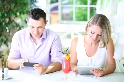 Young couple taking with tablet in restaurant