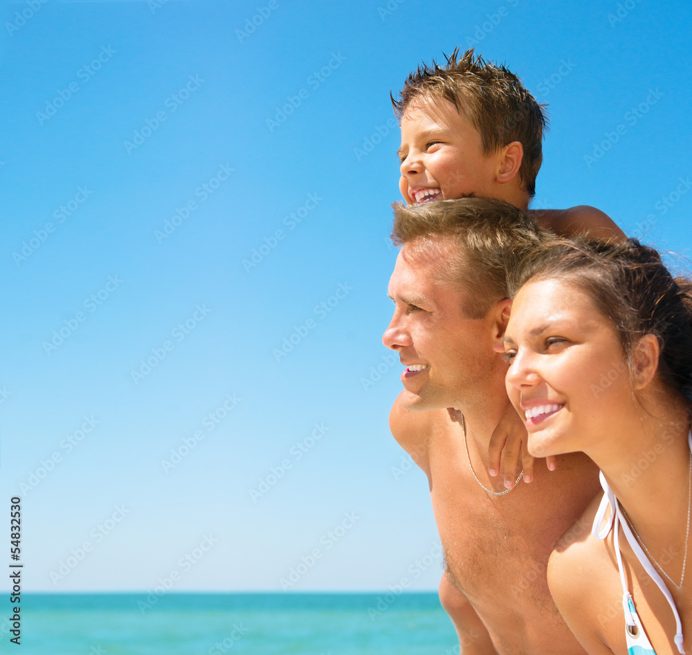 Happy Young Family with Little Kid Having Fun at the Beach Happy Young Family with Little Kid Having Fun at the Beach