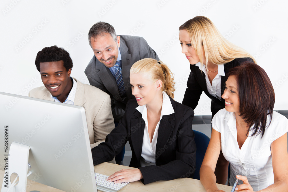 Group Of Businesspeople Looking At Computer Group Of Businesspeople Looking At Computer