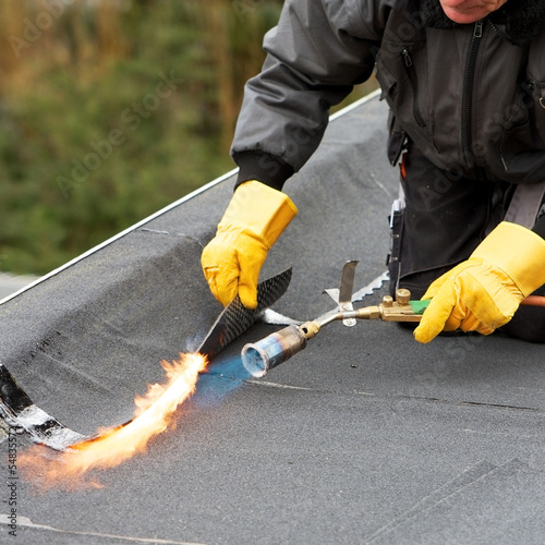 Flat roof covering with roofing felt photo