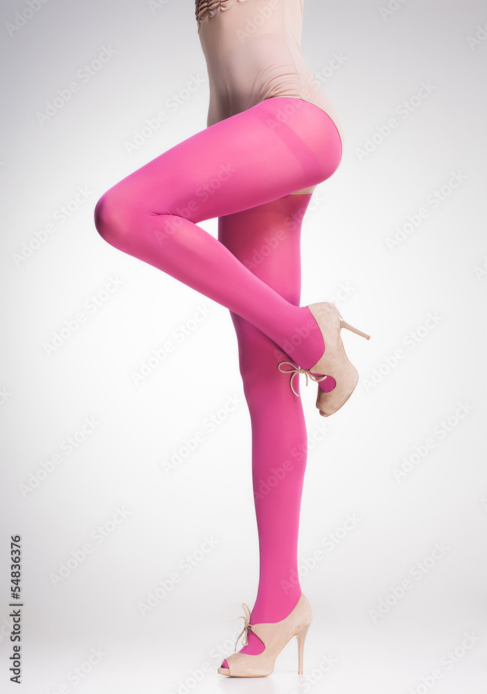 pink stockings on sexy woman legs isolated on grey