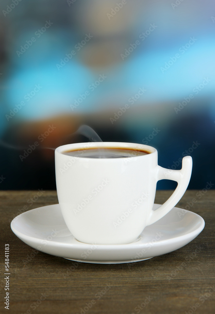 Cup of coffee on wooden table on bright background Cup of coffee on wooden table on bright background