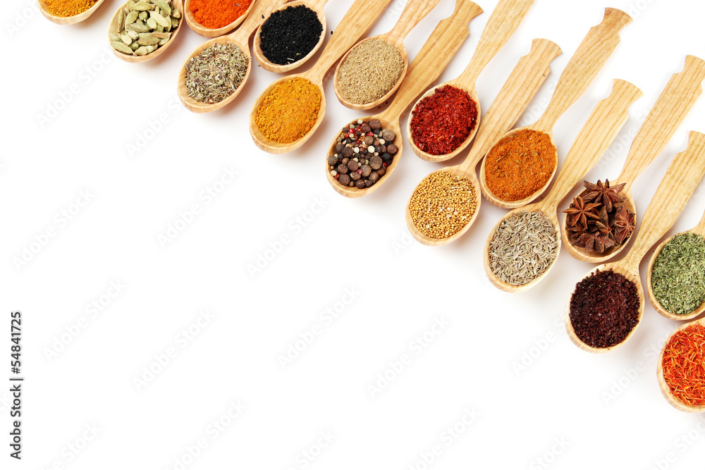 Assortment of spices in wooden spoons, isolated on white Assortment of spices in wooden spoons, isolated on white