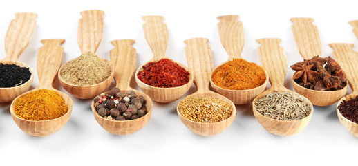 Fototapete Gewürze Assortment of spices in wooden spoons, isolated on white  © Africa Studio