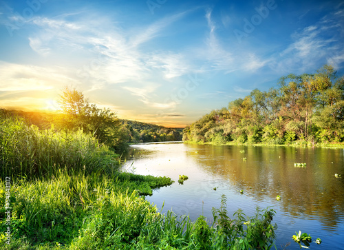 Sunrise over the forest river