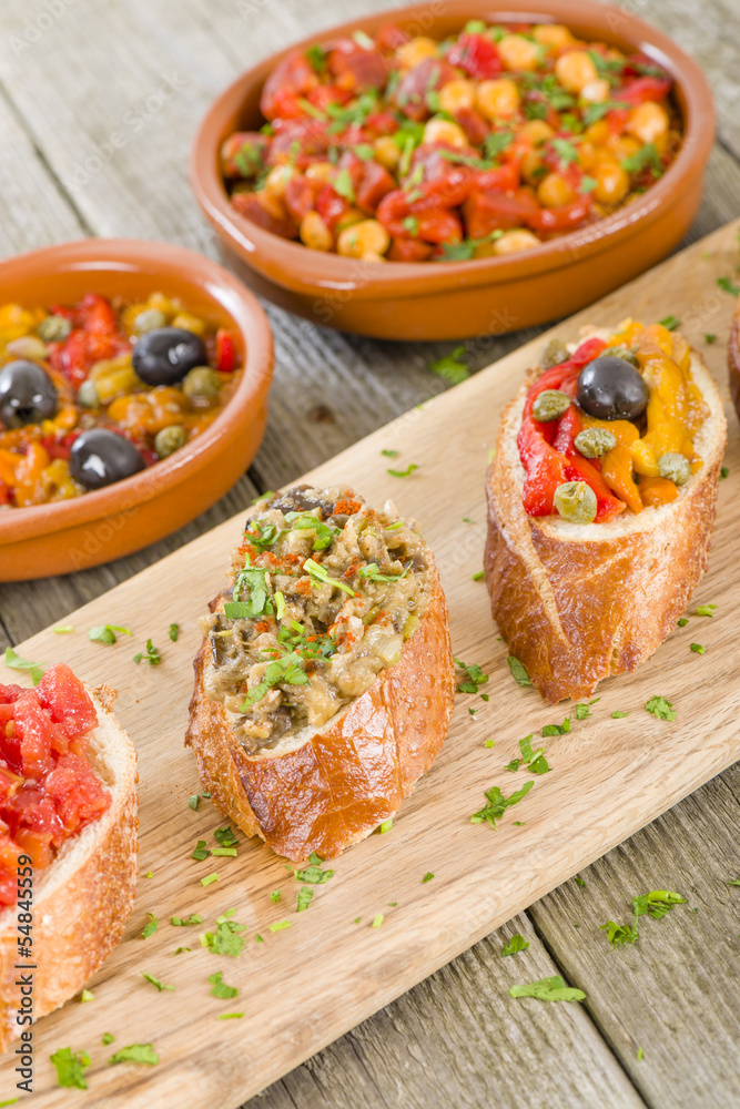 Tapas on Crusty Bread Spanish tapas on a sliced baguette Stock Photo