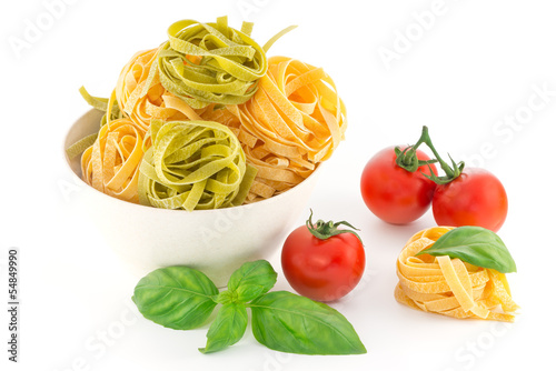Italian pasta tagliatelle nest and cherry tomato isolated on whi