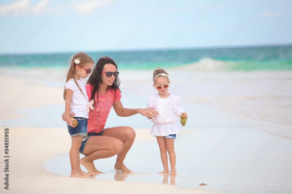 Young mother and her cute daughters enjoy summer vacation at