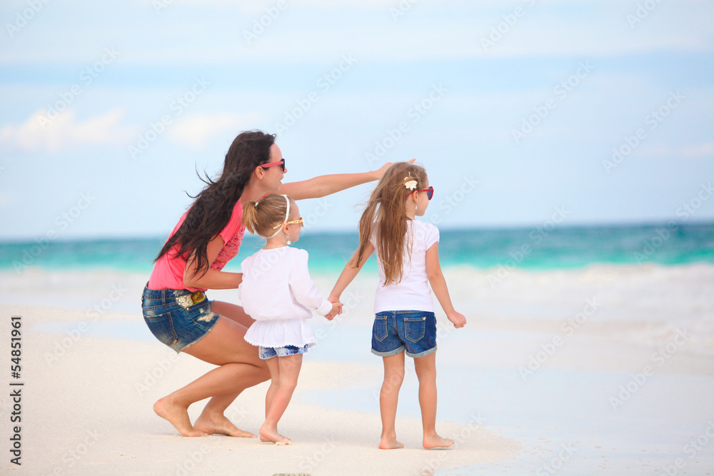 Young mother and her cute daughters enjoy summer vacation at