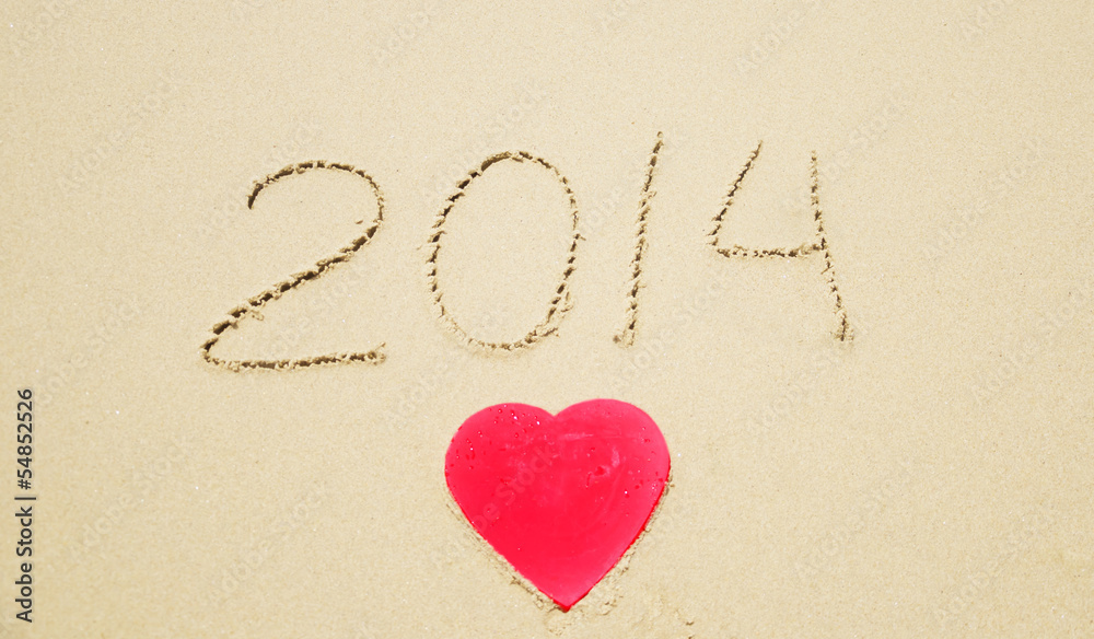 Number 2014 and Heart shape on the beach