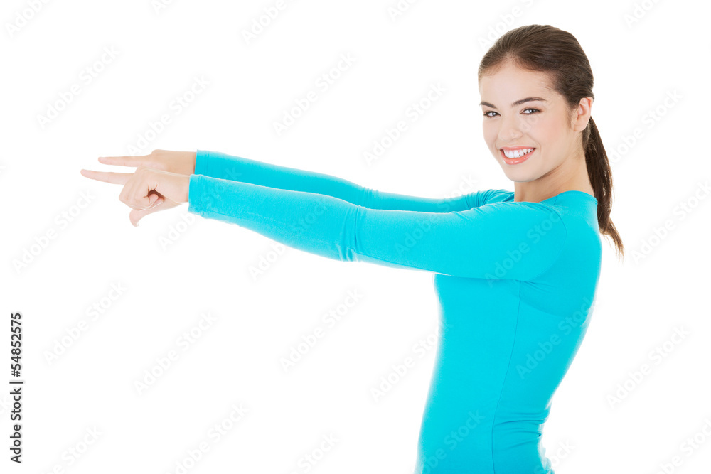 Happy , excited young woman pointing on copy space Happy , excited young woman pointing on copy space