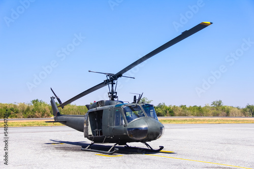 Military helicopter (huey) at a base