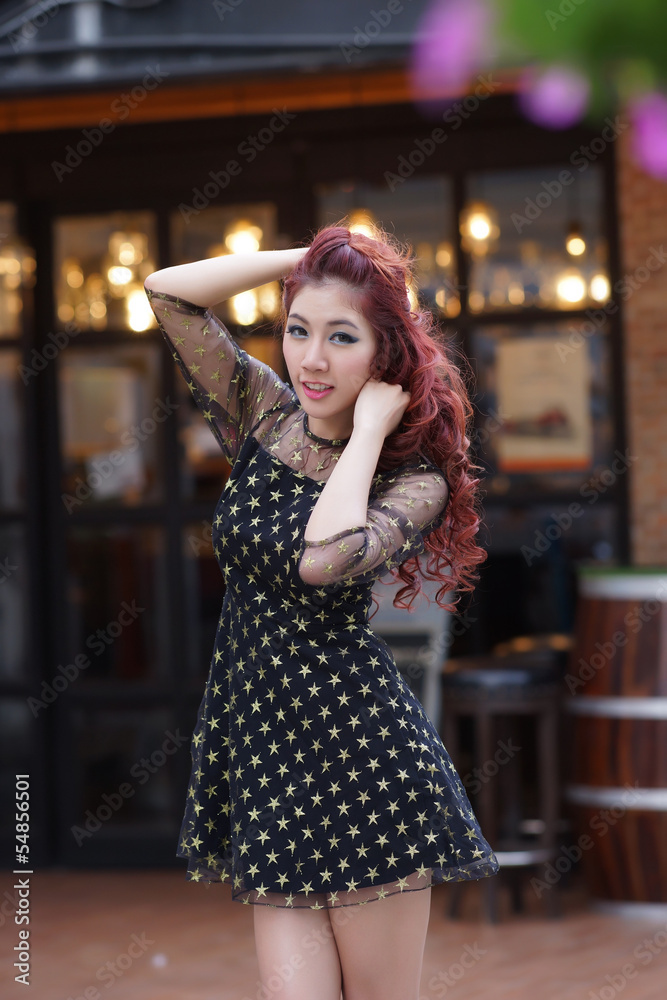 Fototapeta premium Beautiful young woman stand alone at the outdoor mall
