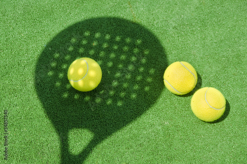 Fotografie Paddle tennis racket shadow on ball.