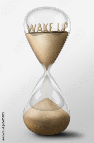 Hourglass with Wake Up made of sand. Concept of work