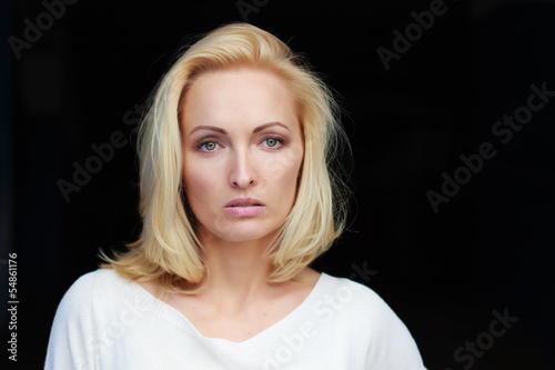 Portrait of a beautiful young glamour girl on a dark background
