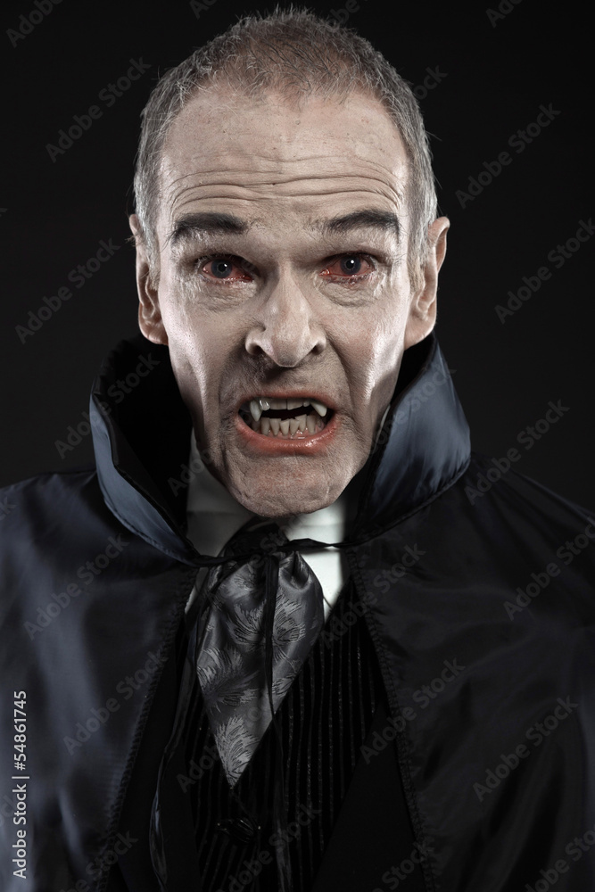 Naklejka premium Dracula with black cape showing his scary teeth. Vamp fangs. Stu