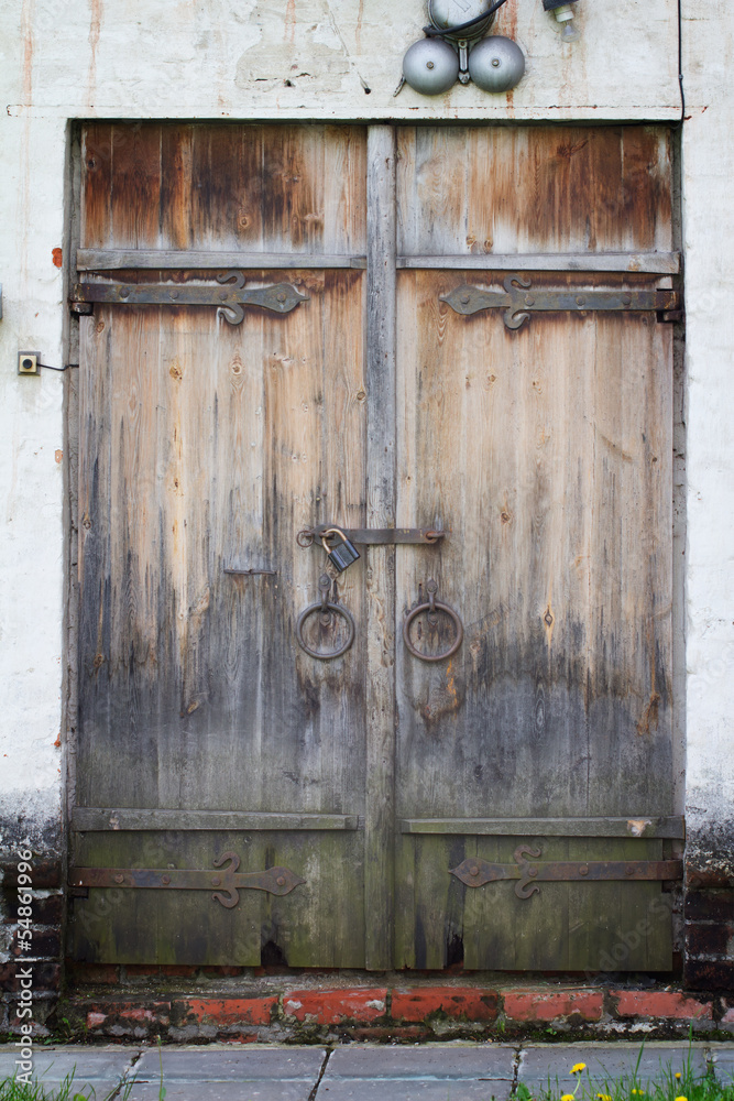 Old aged wooden door with white brick wall in Novodevichy Conven