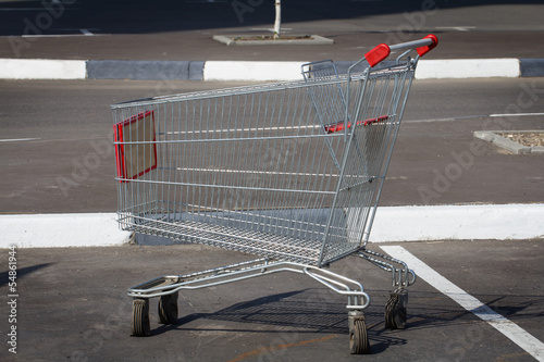 Empty shopping cart in parking lot.