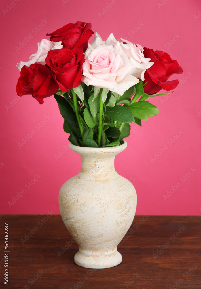 Beautiful bouquet of roses in vase with gift