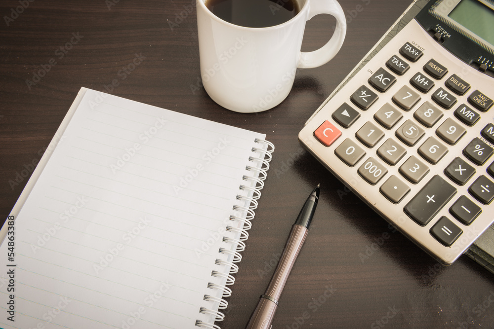 Coffee cup, Document file , pen , Calculator , notepad on woode Coffee cup, Document file , pen , Calculator , notepad on woode