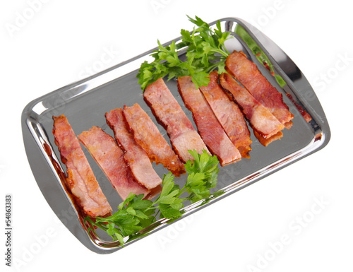 Fried bacon on metal tray isolated on white